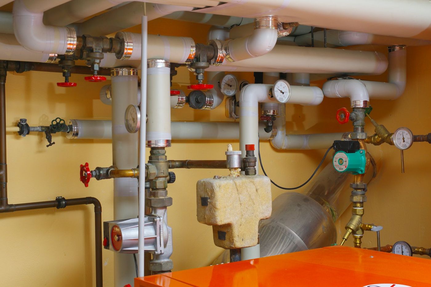 Mechanical room with water piping, valves, pumps and gauges
